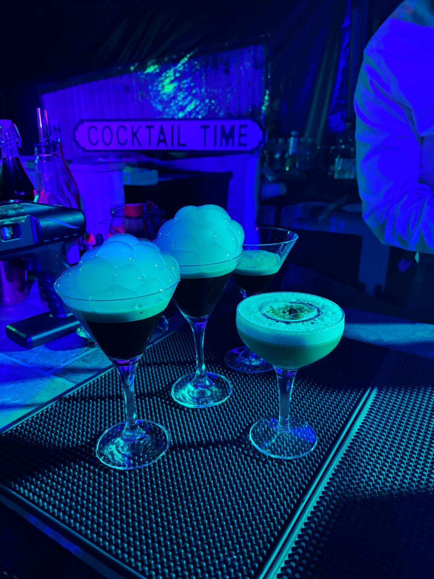 Signature espresso martinis and cocktails under neon lighting