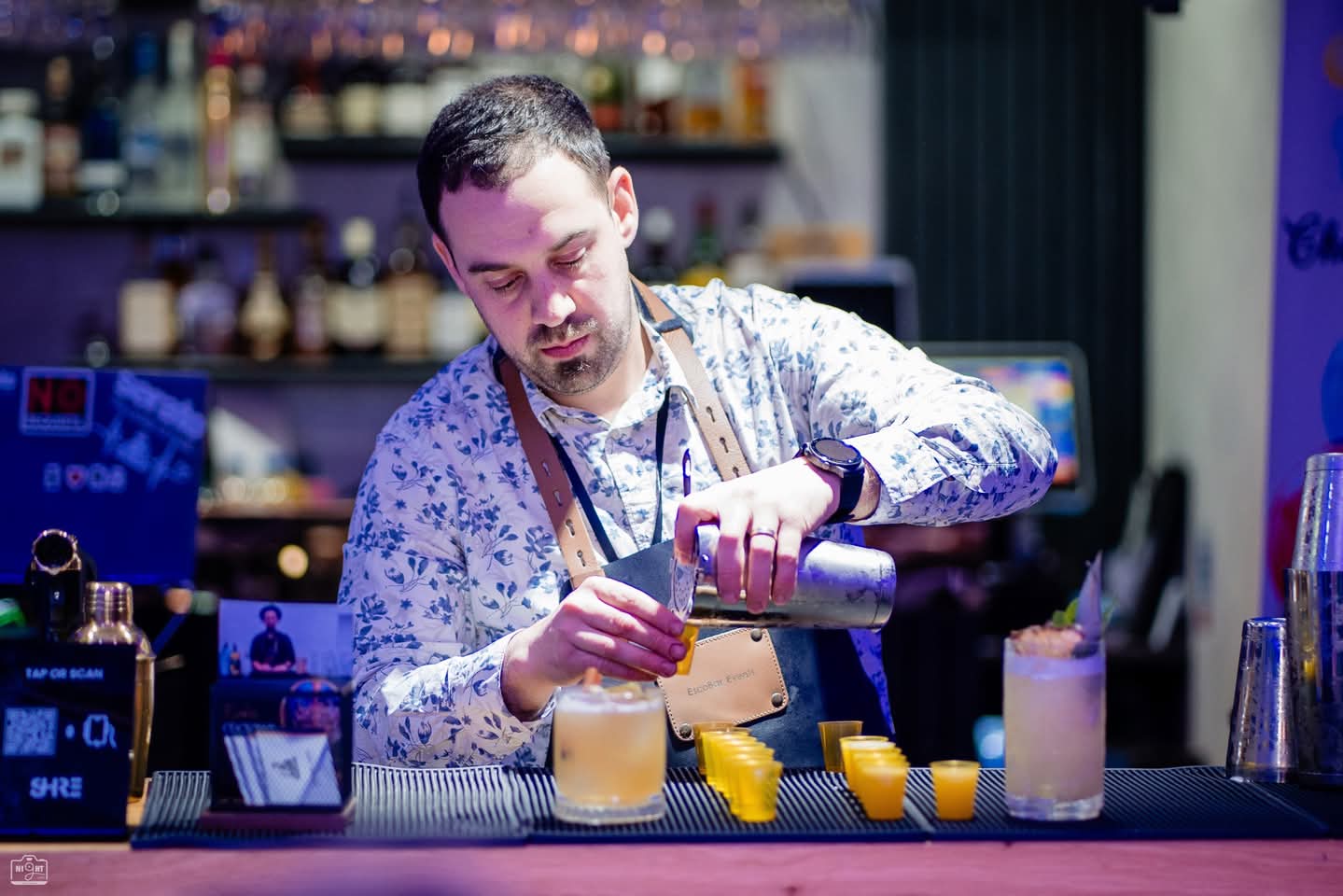 Professional bartender pouring fresh cocktails at an event